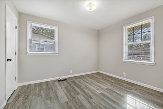 unfurnished room with light hardwood / wood-style flooring