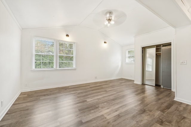 empty room featuring crown molding, ceiling fan, vaulted ceiling, and dark hardwood / wood-style flooring