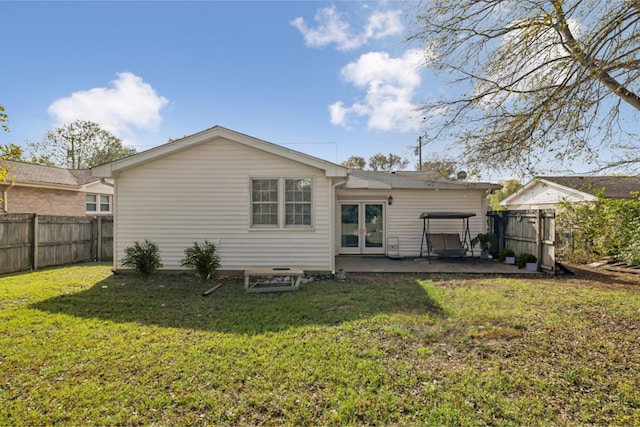 rear view of property with a patio area and a lawn