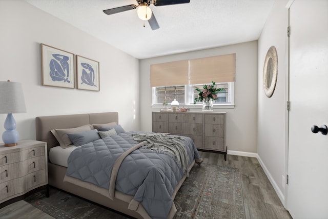 bedroom with a textured ceiling, hardwood / wood-style flooring, and ceiling fan