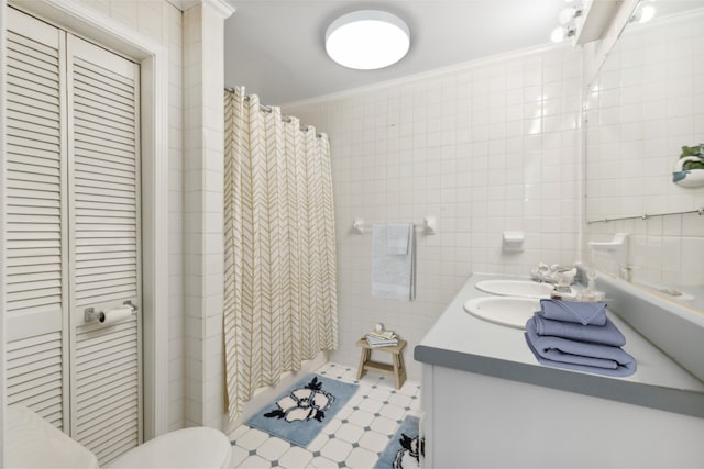 bathroom featuring curtained shower, toilet, tile walls, vanity, and ornamental molding