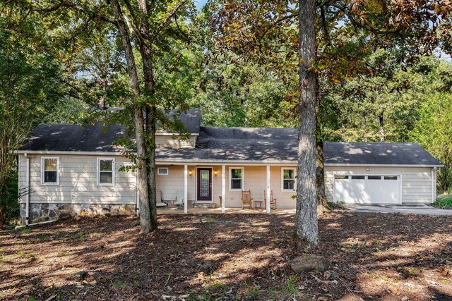 ranch-style house featuring a porch and a garage