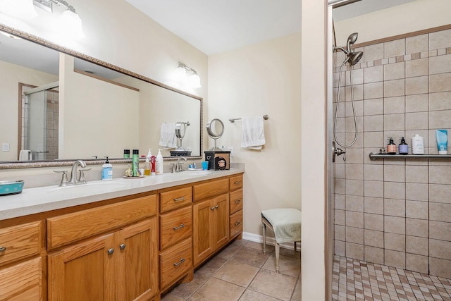 full bath featuring a sink, a shower stall, and double vanity