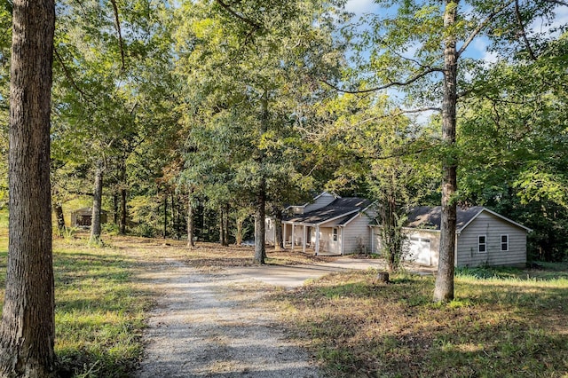 view of front of home featuring a garage and gravel driveway