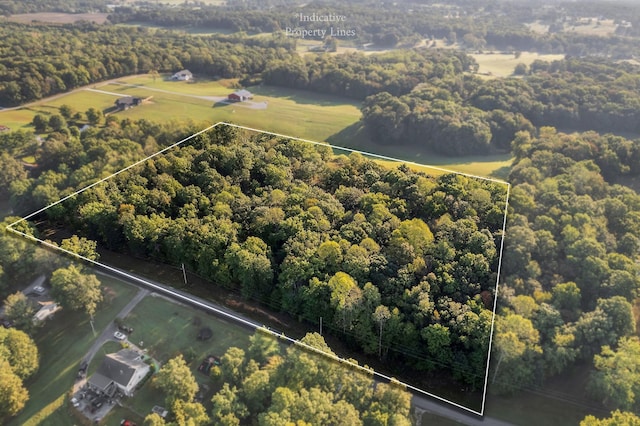 birds eye view of property with a wooded view