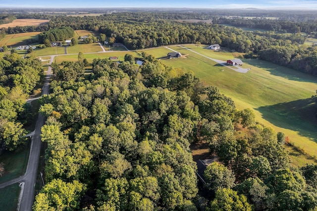 aerial view featuring a view of trees and a rural view