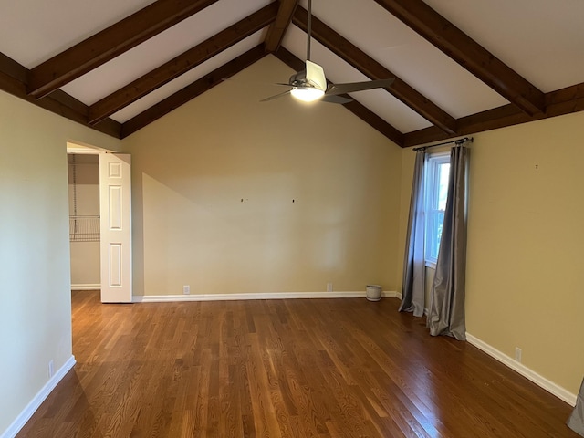 empty room featuring ceiling fan, baseboards, dark wood finished floors, and beamed ceiling