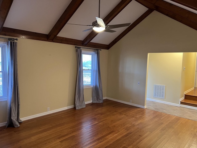 unfurnished room featuring beam ceiling, visible vents, ceiling fan, wood finished floors, and baseboards