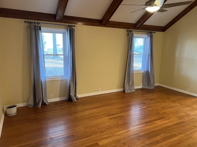 unfurnished room featuring a ceiling fan, vaulted ceiling with beams, baseboards, and wood finished floors