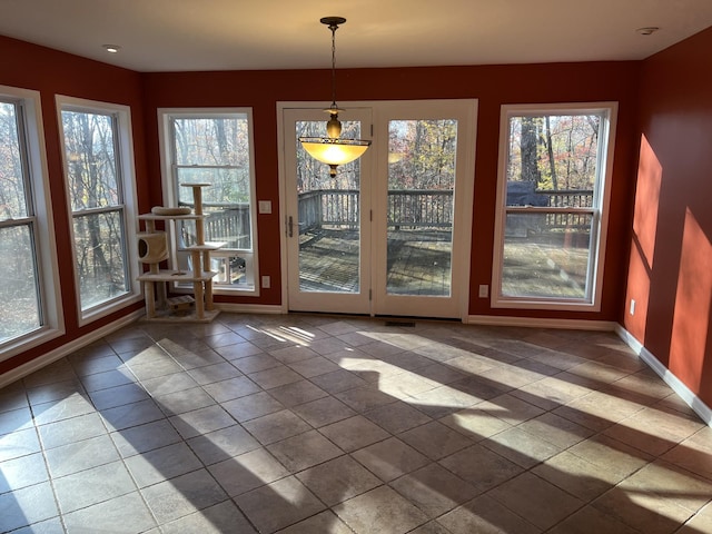 interior space featuring baseboards and tile patterned floors