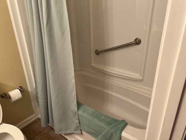 bathroom with toilet, a shower with curtain, and tile patterned floors