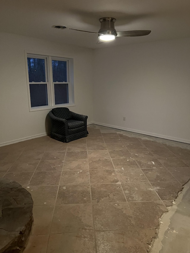 sitting room featuring baseboards and a ceiling fan