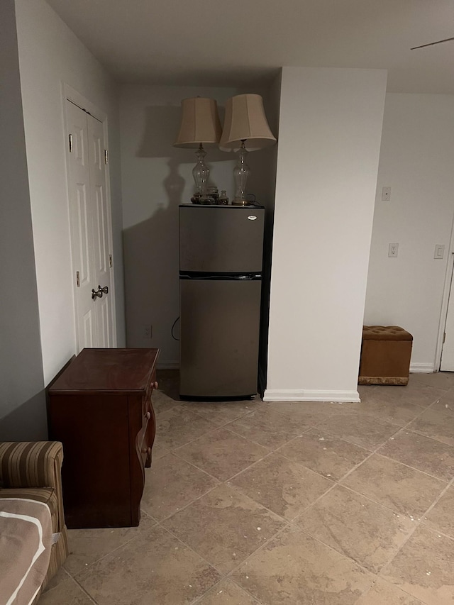 kitchen featuring freestanding refrigerator and baseboards