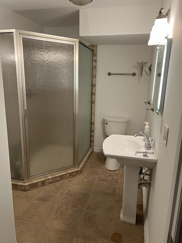 bathroom with toilet and a stall shower