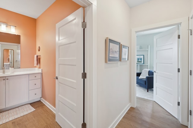 interior space with vanity and hardwood / wood-style flooring