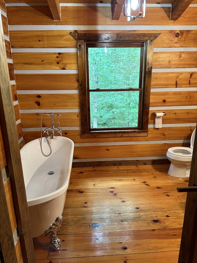 bathroom with toilet and a bathing tub