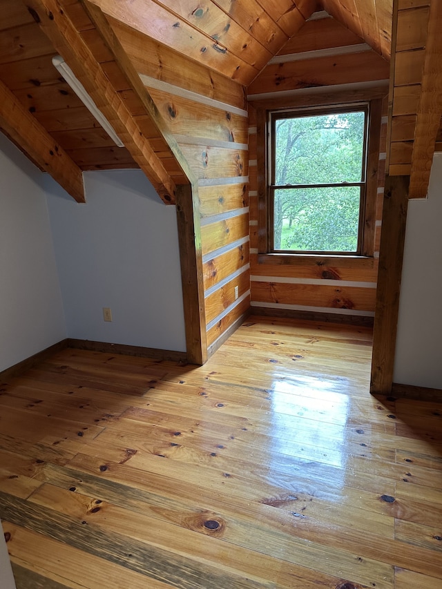 additional living space with light wood-type flooring, lofted ceiling, and wooden ceiling