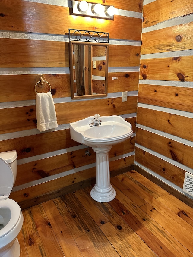 bathroom featuring hardwood / wood-style floors and toilet