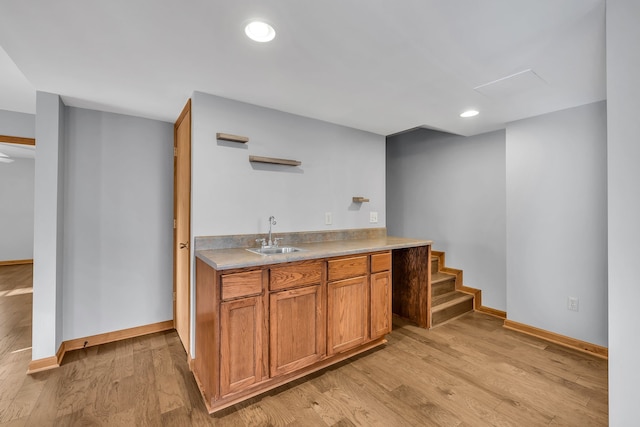 bar featuring sink and light wood-type flooring