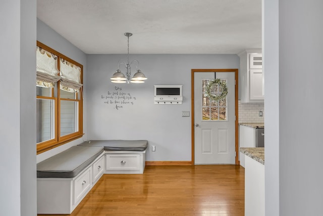 interior space featuring an inviting chandelier and light wood-type flooring