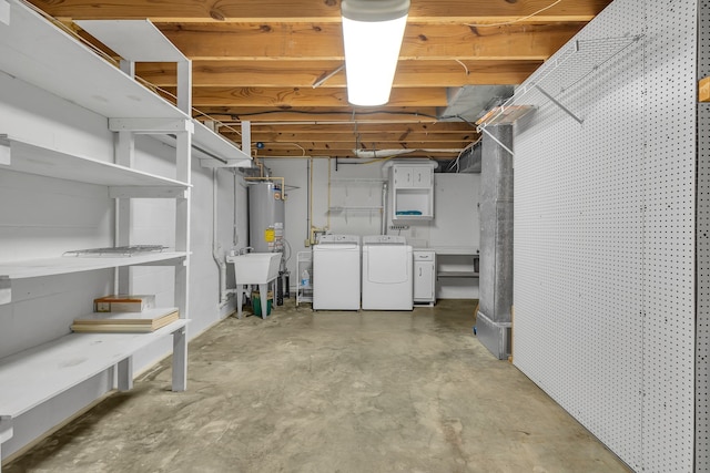 basement with separate washer and dryer, water heater, and sink