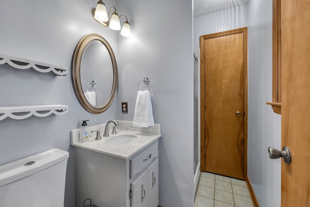 bathroom featuring vanity, a shower with door, tile patterned floors, toilet, and a textured ceiling