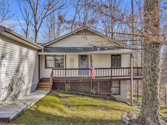 view of front facade featuring a front yard and a wooden deck