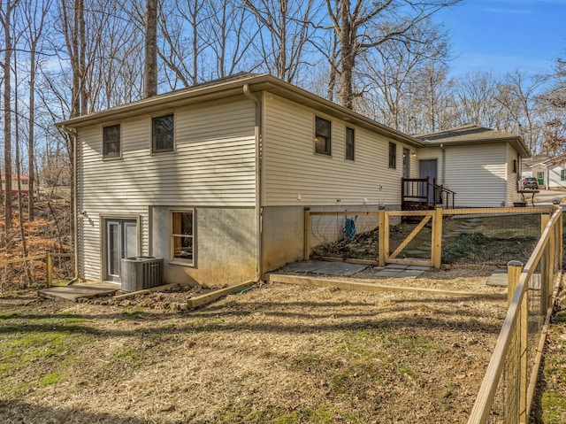 view of home's exterior with central air condition unit, a yard, and a wooden deck