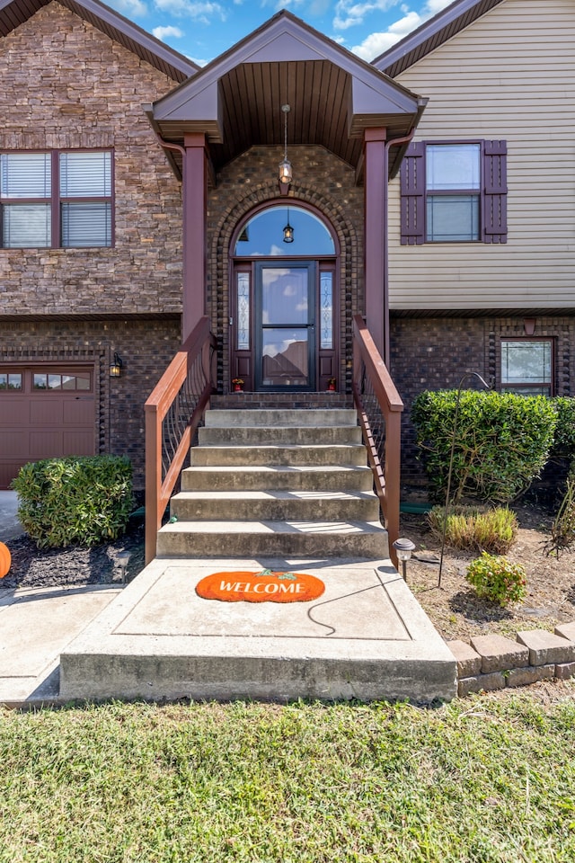 doorway to property with a garage