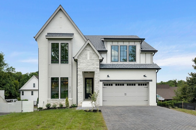 view of front of property featuring a garage and a front yard