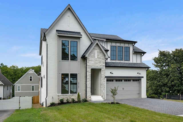 view of front of home featuring a front yard and a garage