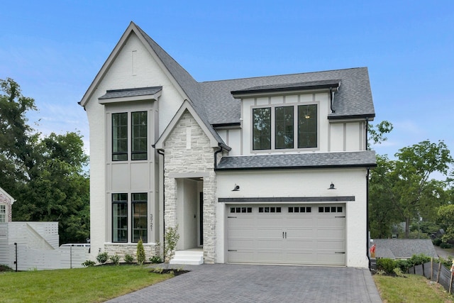 view of front of property with a garage and a front lawn