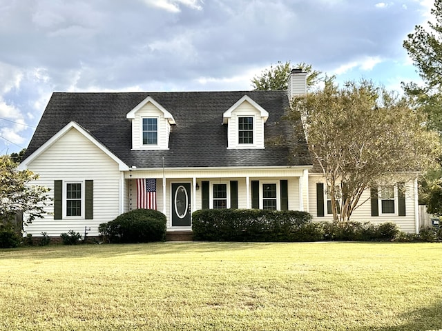 cape cod house featuring a front lawn