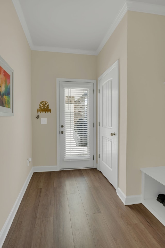 doorway with crown molding and light hardwood / wood-style flooring