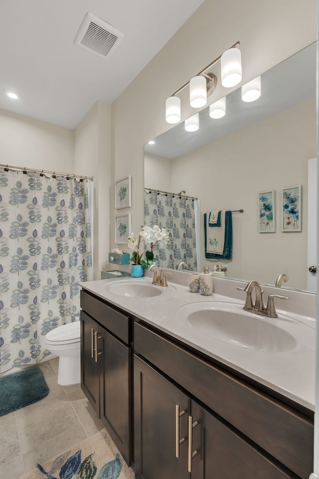 bathroom with tile patterned floors, walk in shower, vanity, and toilet