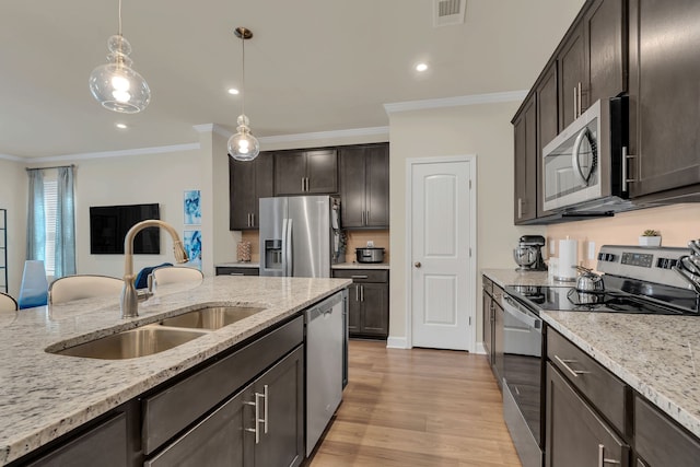 kitchen with stainless steel appliances, crown molding, sink, and light hardwood / wood-style flooring