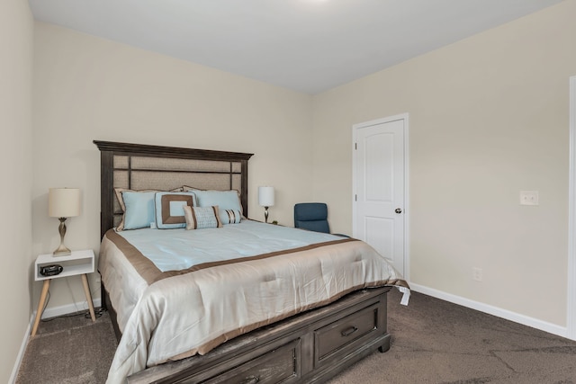 bedroom featuring dark carpet