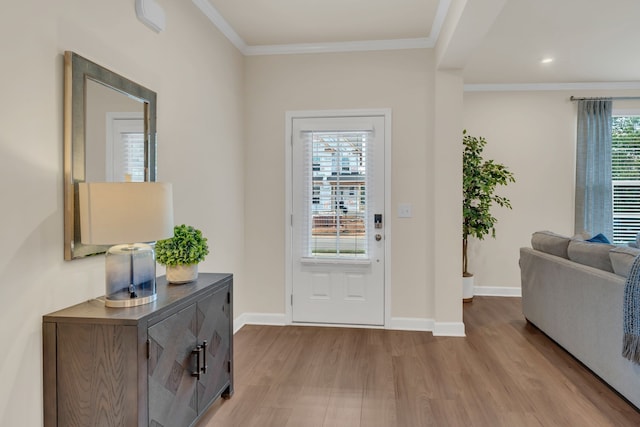 doorway featuring light hardwood / wood-style flooring, plenty of natural light, and crown molding