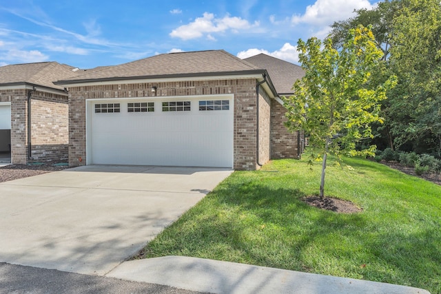 view of front of house with a garage and a front lawn