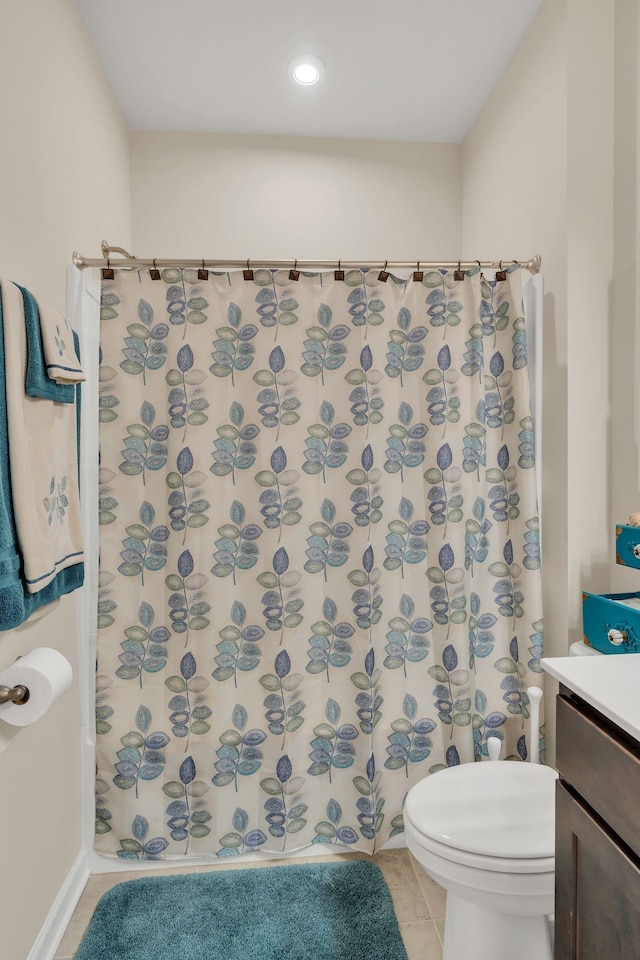 bathroom with walk in shower, vanity, toilet, and tile patterned floors