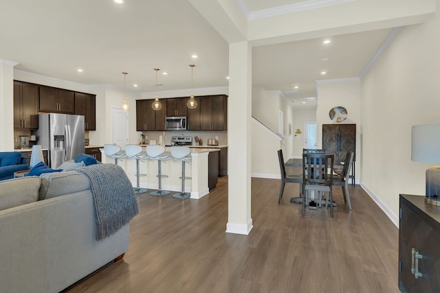 living room featuring ornamental molding and dark hardwood / wood-style flooring