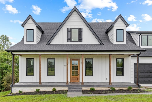 modern farmhouse style home featuring a porch, a garage, board and batten siding, and roof with shingles