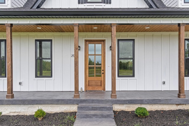 property entrance featuring board and batten siding and a porch