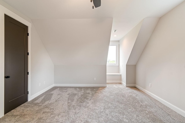 bonus room with baseboards, visible vents, lofted ceiling, and carpet flooring