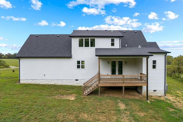 rear view of house with a deck, roof with shingles, crawl space, stairway, and a yard