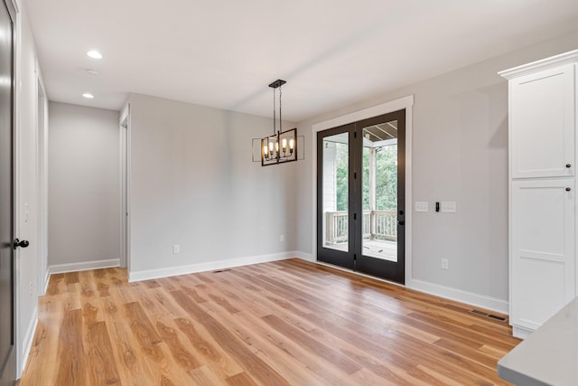 unfurnished dining area featuring light wood-style flooring, visible vents, baseboards, an inviting chandelier, and recessed lighting