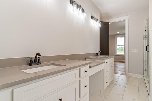 full bath featuring vanity, a shower stall, marble finish floor, and baseboards