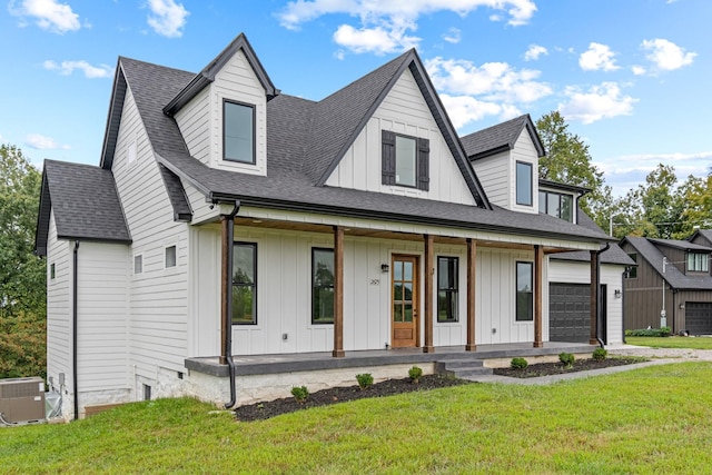 modern farmhouse featuring board and batten siding, covered porch, a shingled roof, central air condition unit, and a front yard