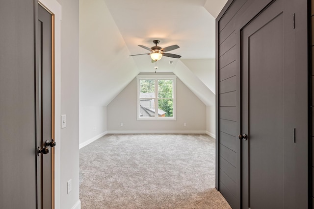 additional living space featuring carpet flooring, ceiling fan, lofted ceiling, and baseboards
