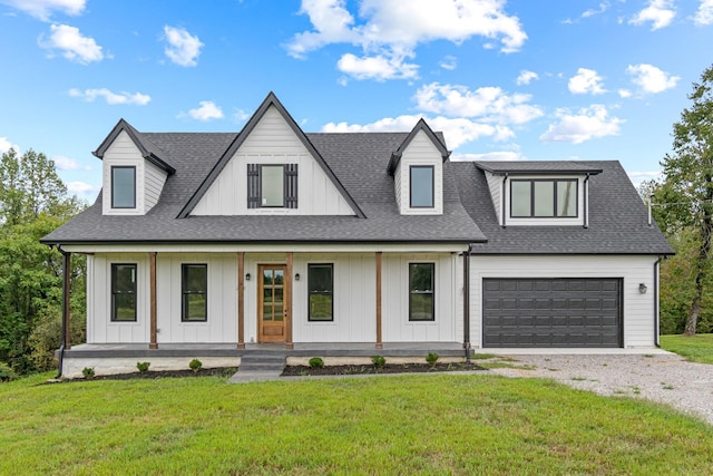 modern inspired farmhouse featuring a porch, a front yard, driveway, and roof with shingles